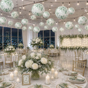 Green floral paper lanterns hang over an indoor banquet hall setup - thumbnail number 2