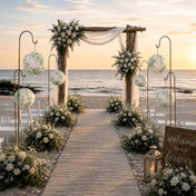 Green floral paper lanterns hang along a wooden beach wedding aisle - thumbnail number 5