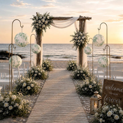 Green floral paper lanterns hang along a wooden beach wedding aisle - thumbnail number 5