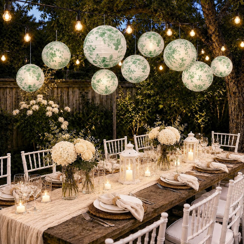 Green floral paper lanterns hang over an outdoor dinner party table - thumbnail number 3
