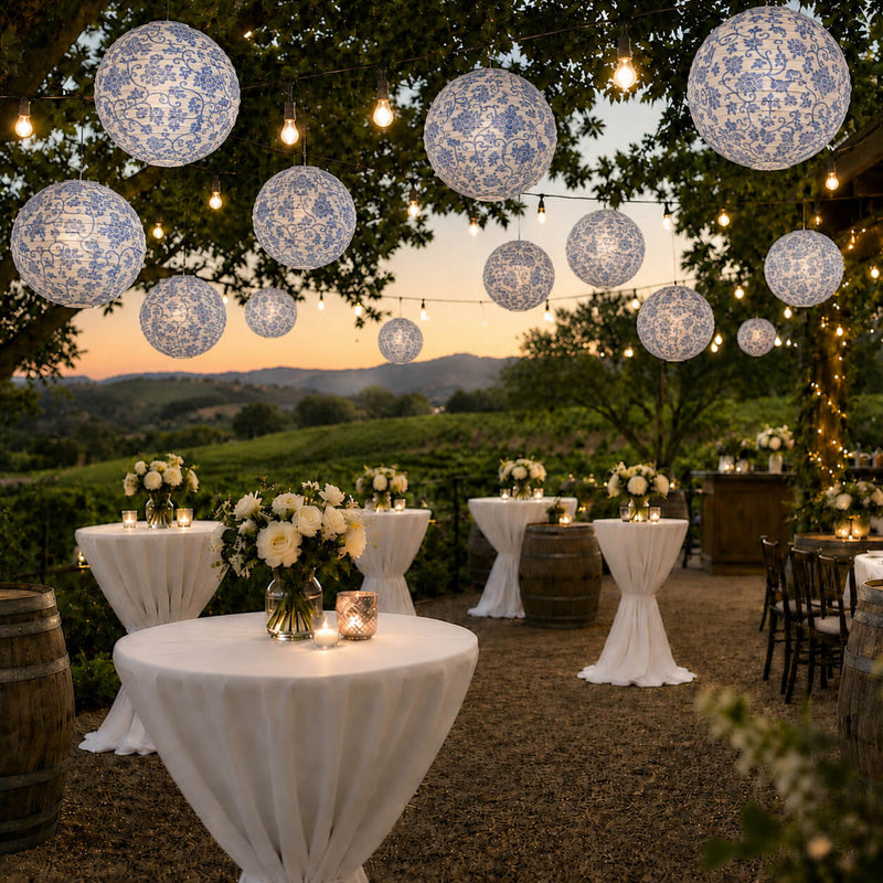 Blue and white French toile paper lanterns hanging over an outdoor vineyard reception - thumbnail number 6