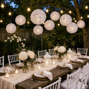 Blue and white French toile paper lanterns hanging over an outdoor dinner party table - thumbnail number 7