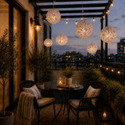 Blue and white French toile paper lanterns hanging over an urban balcony seating area - thumbnail number 8