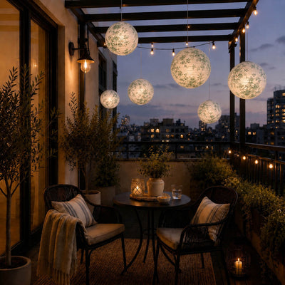 White and green toile paper lanterns hanging over a city balcony at dusk - thumbnail number 8