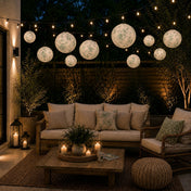 White and green toile paper lanterns hanging over an outdoor patio seating area - thumbnail number 9