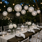 Hanging silver payette sequin lanterns over an outdoor garden dinner party - thumbnail number 4