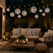 Hanging silver payette sequin lanterns glowing over a cozy patio lounge at night - thumbnail number 10