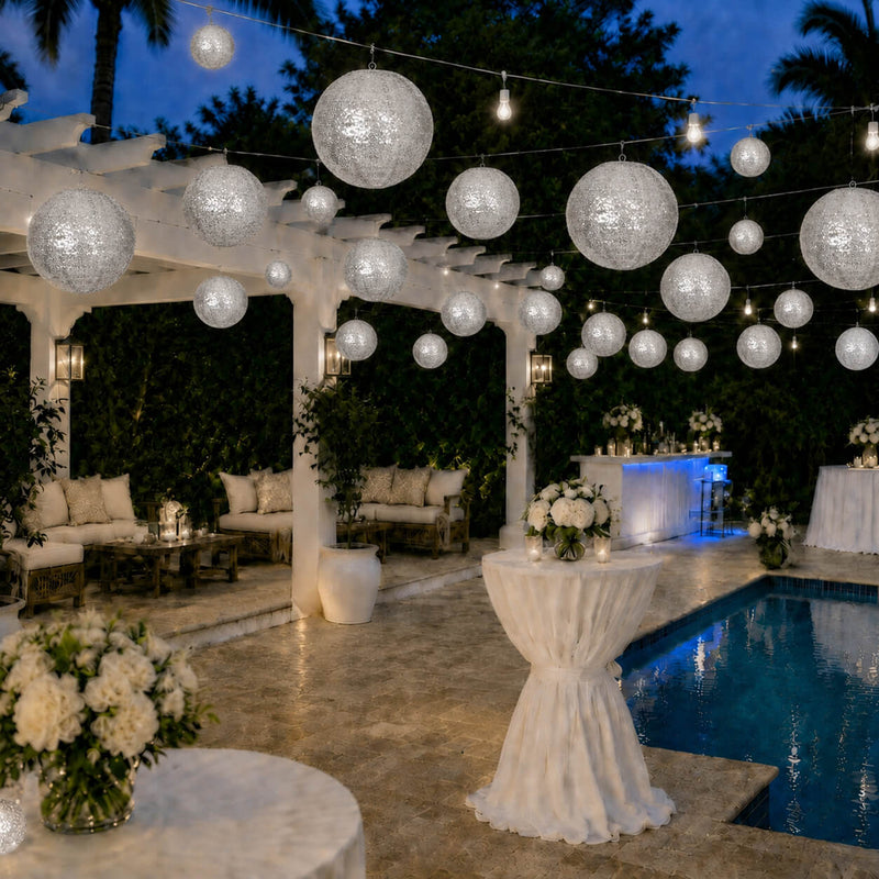 Shimmering silver sequin hanging lanterns illuminate an outdoor poolside event space - thumbnail number 4