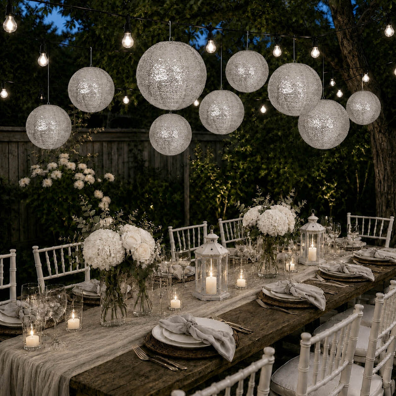 Silver sequin hanging lanterns illuminated over an outdoor dinner table - thumbnail number 5