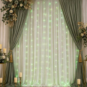 Green LED micro fairy lights hanging as a backdrop behind sheer white curtains - thumbnail number 6