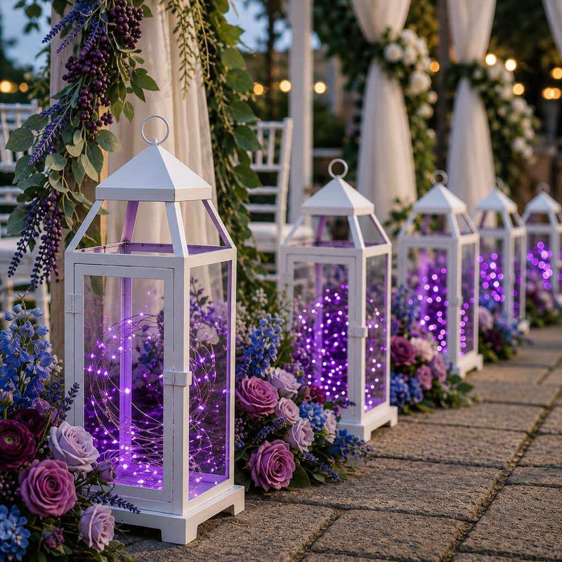 White lanterns with purple LED fairy lights placed along an aisle with flowers - thumbnail number 4