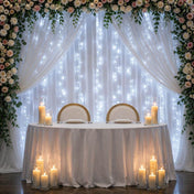 White LED fairy light backdrop behind a decorated wedding sweetheart table - thumbnail number 6
