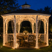 Warm white LED curtain lights decorating an outdoor wooden gazebo dining area at night - thumbnail number 6