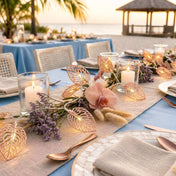 Rose gold leaf string lights decorating a beachside wedding table - thumbnail number 4