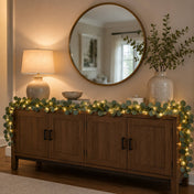Eucalyptus garland string lights draped across a wooden console table - thumbnail number 9