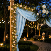 Rose and light garland draped over a wooden arch with blue fabric - thumbnail number 6