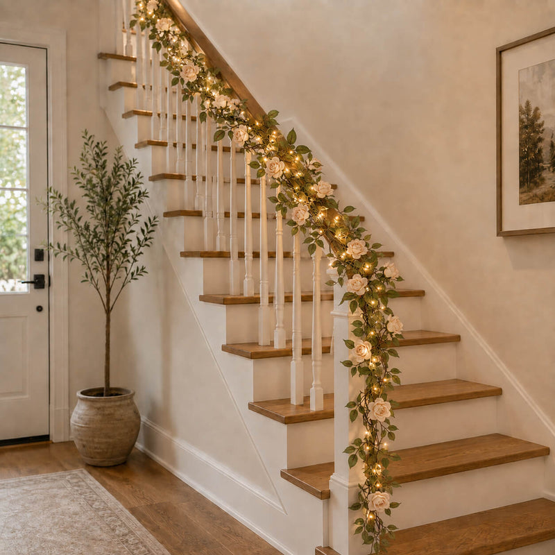 Rose and light garland draped down an indoor staircase banister - thumbnail number 10