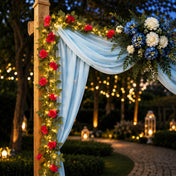 A 7ft red silk rose flower garland with 20 LED string lights decorating an outdoor wedding arch - thumbnail number 4