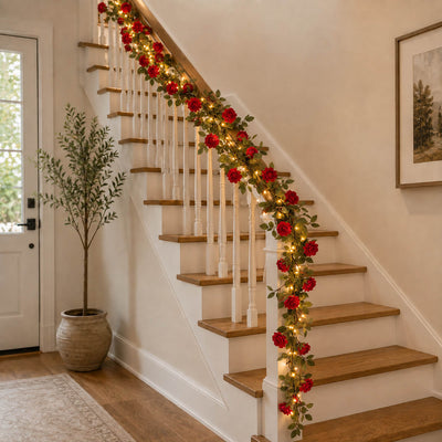 A 7ft red silk rose flower garland with 20 LED string lights draped along a staircase railing - thumbnail number 8