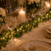 Ivy garland string lights running down a candlelit dining table centerpiece - thumbnail number 5