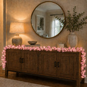 Pink cherry blossom LED garland decorating a wooden sideboard - thumbnail number 9
