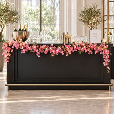LED pink jasmine garland decorating a black wedding bar - thumbnail number 12