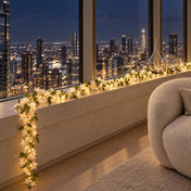 White jasmine flower garland with fairy lights on a windowsill overlooking city lights - thumbnail number 11