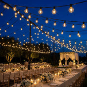Hanging string lights illuminating an outdoor wedding reception at night - thumbnail number 6