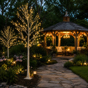 Two 6ft lighted birch trees with warm white LEDs standing on a garden path near a gazebo - thumbnail number 10