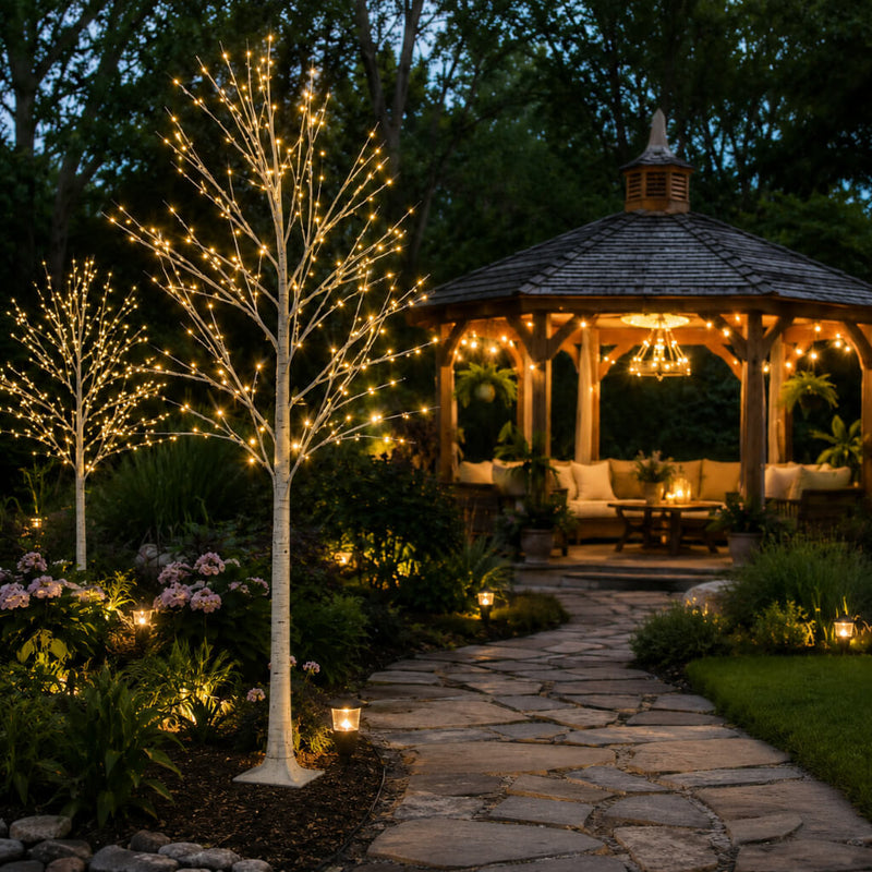 Two 6ft lighted birch trees with warm white LEDs standing on a garden path near a gazebo - thumbnail number 10