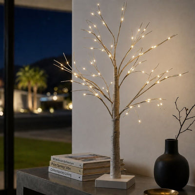 2ft lit birch tree with warm LED fairy lights on a modern table next to stacked books - thumbnail number 6