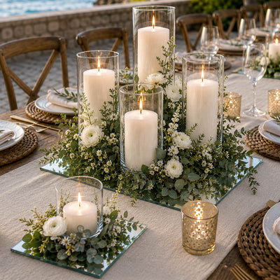 Lit pillar candles in glass cylinders with flowers on mirror glasses for table decor - thumbnail number 5