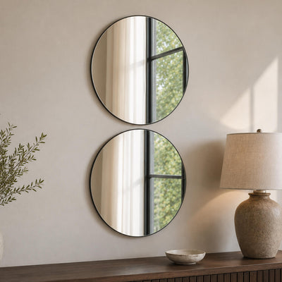 Two 14 round mirrors mounted vertically on a light wall above a wood console table - thumbnail number 6