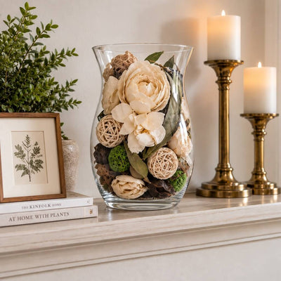 Glass vase filled with dried potpourri flowers on a mantelpiece - thumbnail number 8