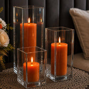 A cozy home centerpiece featuring a trio of orange candles in a Square Pillar Candle Holder set - thumbnail number 8