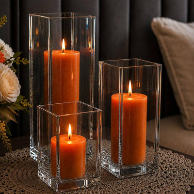 A cozy home centerpiece featuring a trio of orange candles in a Square Pillar Candle Holder set - thumbnail number 8