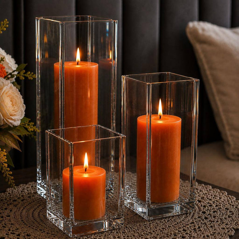 A cozy home centerpiece featuring a trio of orange candles in a Square Pillar Candle Holder set - thumbnail number 8