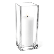 Warm candle flame glowing from within a tall glass Square Pillar Candle Holder 12" on white - thumbnail number 3