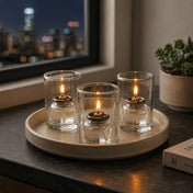 Three lit fuel cell candles on modern tabletop beside window - thumbnail number 8