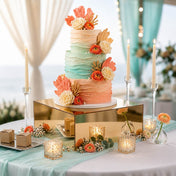 Gold mirror acrylic riser showcasing a tiered coastal wedding cake with coral and teal frosting - thumbnail number 5