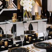 Mirrored rectangular centerpiece stand styled with candles and white orchids on a black and gold table - thumbnail number 4