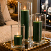 Three lit dark green candle and square holder sets arranged on a gold tray with a city backdrop - thumbnail number 7
