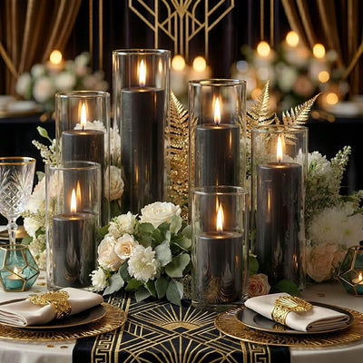 Elegant centerpiece of lit black candles in glass cylinders and floral decor - thumbnail number 5