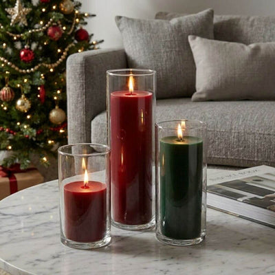 Red and green pillar candles in glass cylinder vases on a table - thumbnail number 6
