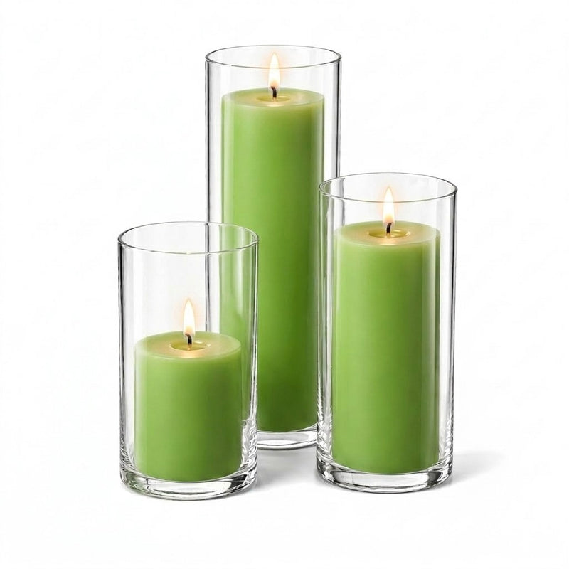Three lit green pillar candles inside clear glass cylinder holders of varying heights - thumbnail number 2