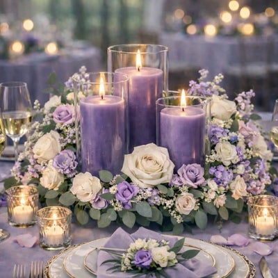 Lavender pillar candles in glass vases with a round floral centerpiece - thumbnail number 3