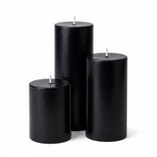Three unlit black pillar candles in varied heights on a white background - thumbnail number 1