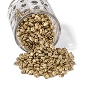 A glass jar spilling out small metallic gold stones for vase filler and decor - thumbnail number 1