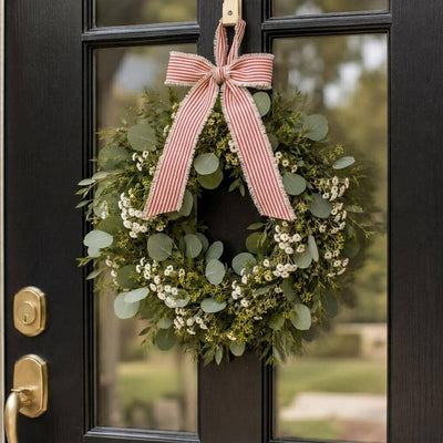 Greenery and white floral wreath hanging on a black door with a red and white striped linen bow - thumbnail number 7