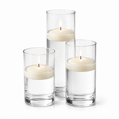 Three light ivory floating candles in glass cylinders on a white background - thumbnail number 1